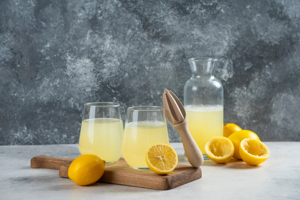 two cups of lemon juice on a wooden board 2021 09 03 03 09 33 utc.jpg