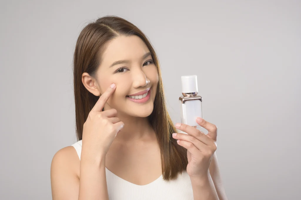 Preventive Dermatology: 4 Easy Steps for Healthy Skin smiling woman presenting skincare product 2026 09 21 13 09 14 utc